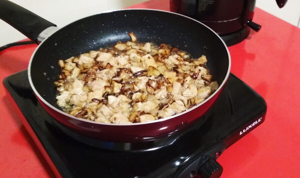 Tuna added to fried onions cooking